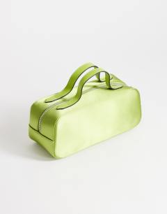 Model wearing Dover medium satin top handle grab bag in green