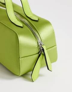 Model wearing Dover medium satin top handle grab bag in green