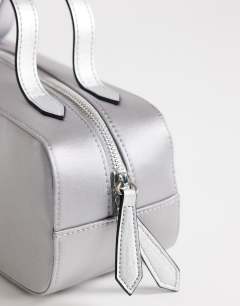 Model wearing Dover medium satin top handle grab bag in grey