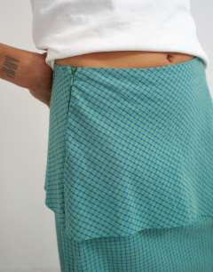 Model wearing Drape detail maxi skirt in green and blue check