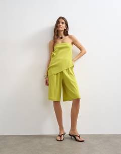 Model wearing Drape detail textured bandeau co-ord top in green