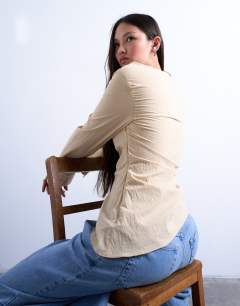 Model wearing Drape neck long sleeve top in yellow stripe
