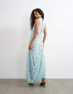 Model wearing Draped hem chiffon midi occasion dress in blue and chocolate polka dot print