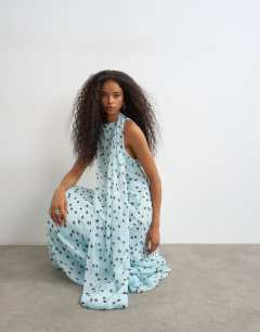 Model wearing Draped hem chiffon midi occasion dress in blue and chocolate polka dot print
