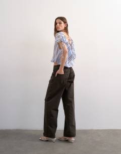 Model wearing Draped high neck top with tie in blue stripe