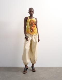 Model wearing Draped knot shoulder detail top in large yellow floral