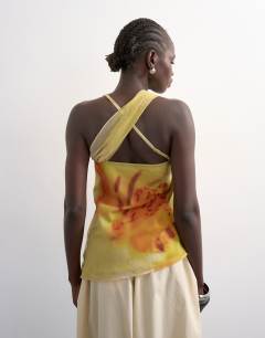 Model wearing Draped knot shoulder detail top in large yellow floral