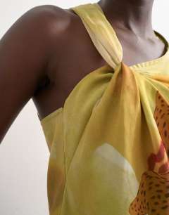 Model wearing Draped knot shoulder detail top in large yellow floral