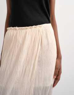 Model wearing Draped pleated fabric maxi skirt in ivory