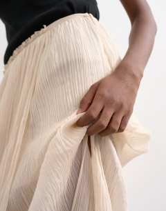 Model wearing Draped pleated fabric maxi skirt in ivory