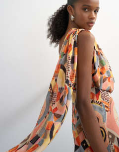 Model wearing Draped scarf neck mini dress in mosaic print