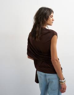 Model wearing Draped wrap high cap sleeve top in chocolate brown