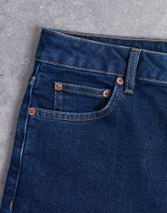 Model wearing Dree high rise slim straight leg jean in indigo rinse