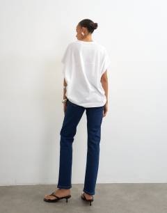Model wearing Dree high rise slim straight leg jean in indigo rinse