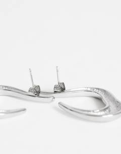 Model wearing Drew waterproof asymmetric hoop earring in silver