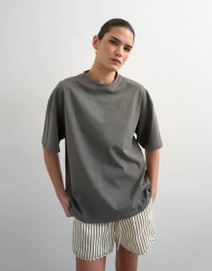Model wearing Drop shoulder mercer graphic print tee in washed black