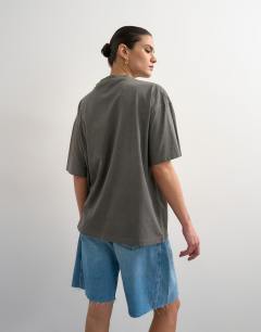 Model wearing Drop shoulder studio graphic print tee in washed black