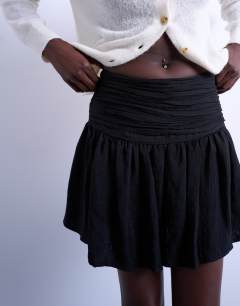 Model wearing Drop waist mini skirt in black