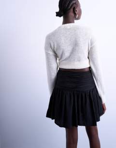 Model wearing Drop waist mini skirt in black