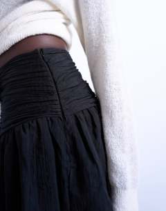 Model wearing Drop waist mini skirt in black