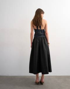 Model wearing Drop waist saloon maxi skirt in black