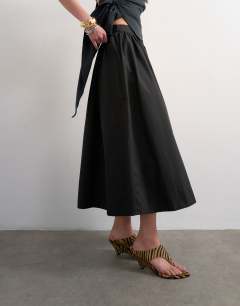 Model wearing Drop waist saloon maxi skirt in black