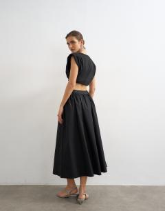 Model wearing Drop waist saloon maxi skirt in black