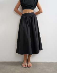 Model wearing Drop waist saloon maxi skirt in black