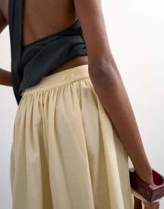 Model wearing Drop waist saloon maxi skirt in buttermilk