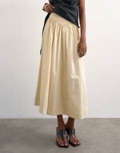 Model wearing Drop waist saloon maxi skirt in buttermilk