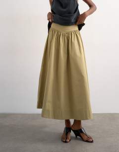 Model wearing Drop waist saloon maxi skirt in green