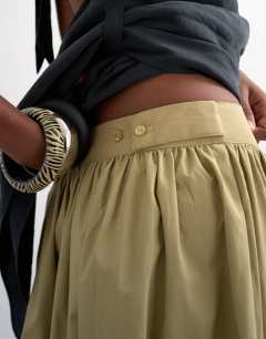 Model wearing Drop waist saloon maxi skirt in green