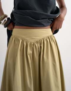 Model wearing Drop waist saloon maxi skirt in green