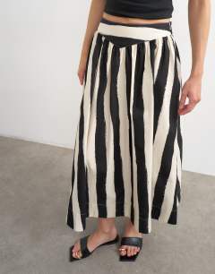 Model wearing Drop waist saloon maxi skirt in mono stripe print