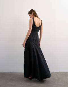 Model wearing Dropped hem full circle skirt sundress in black with contrast top stitch