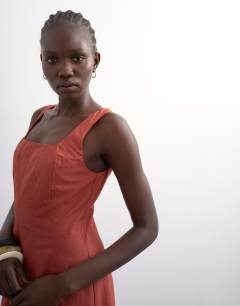 Model wearing Dropped hem full circle skirt sundress in rust