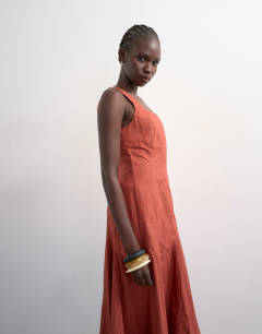 Model wearing Dropped hem full circle skirt sundress in rust