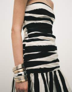 Model wearing Dropped waist bandeau maxi dress in thick mono stripe