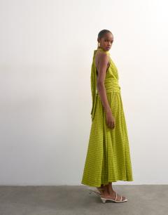 Model wearing Dropped waist halter maxi dress in brown and lime check