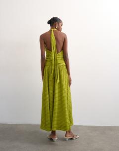 Model wearing Dropped waist halter maxi dress in brown and lime check