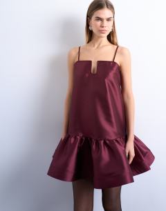 Model wearing Dropped waist peplum hem mini dress in ruby red