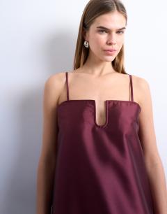 Model wearing Dropped waist peplum hem mini dress in ruby red