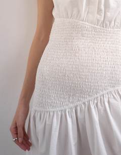 Model wearing Dropped waist sleeveless shirt dress in white