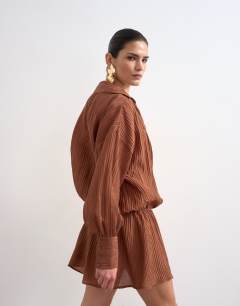 Model wearing Dropped waist wrap shirt dress in textured rust