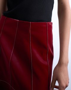 Model wearing Dropwaist contrast stitched PU maxi skirt in red