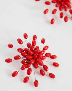 Model wearing Echo statement hand-made stud earring in red