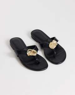 Model wearing Eden toe thong sandal with hardware in black