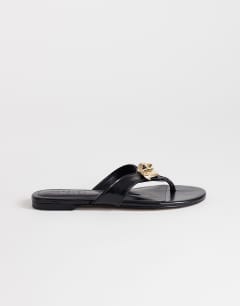 Model wearing Eden toe thong sandal with hardware in black