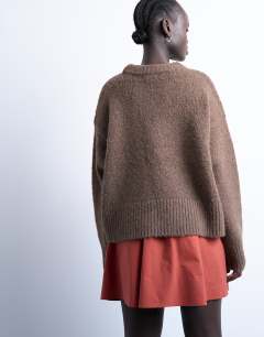 Model wearing Elasticated mini skirt in rust 