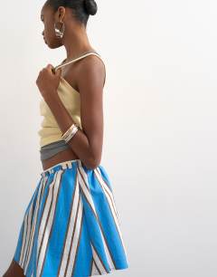 Model wearing Elasticated mini skirt in sporty blue stripe